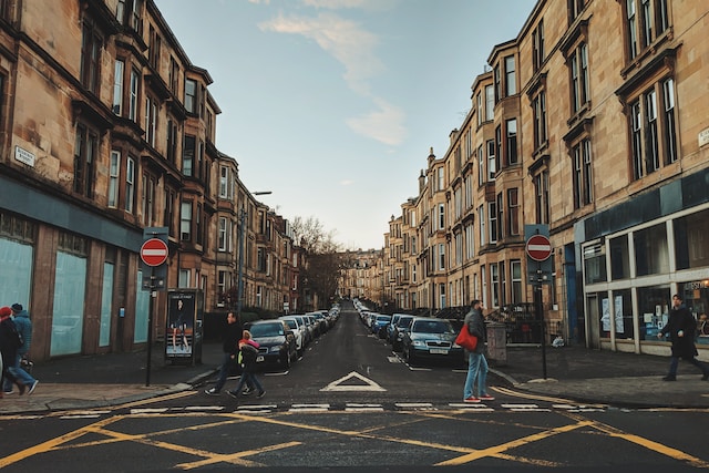 man walking through a street in Glasgow